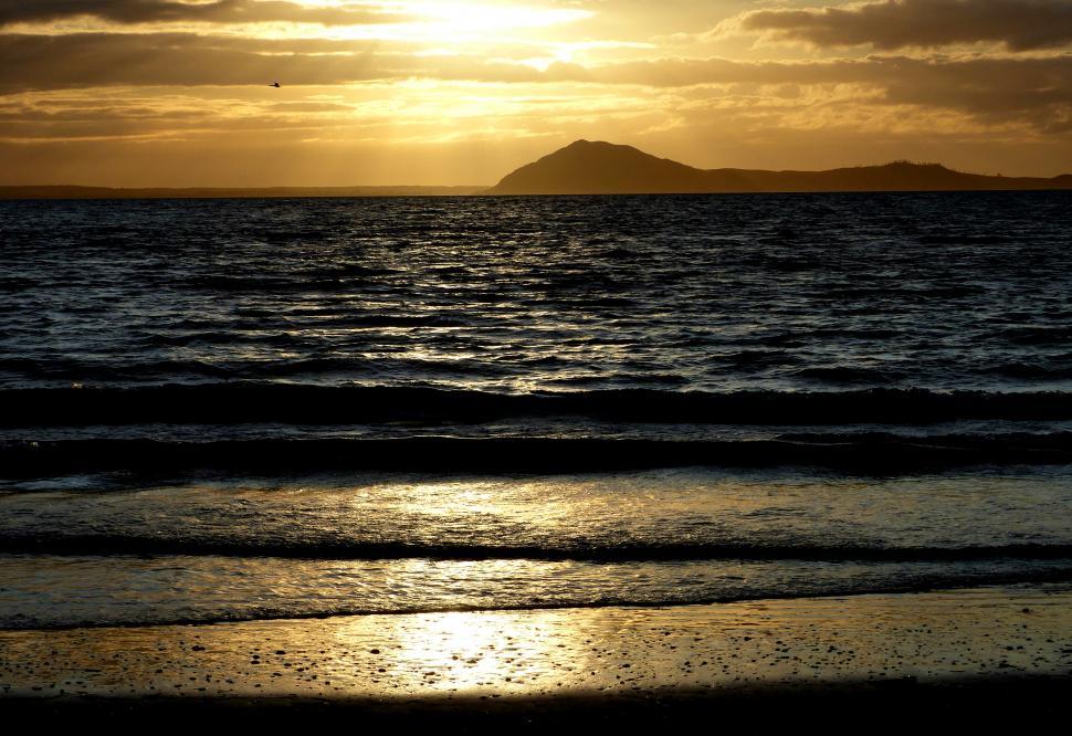 Free Image of A sunset over a body of water 