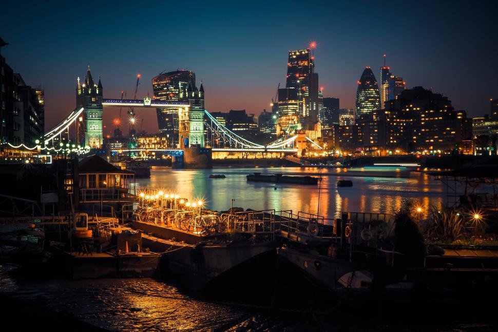 Free Image of A bridge over water with lights at night 