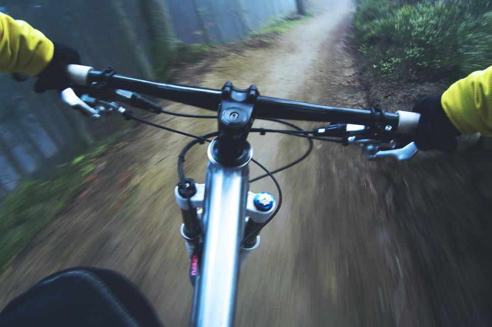 Free Image of A person riding a bike on a dirt road 