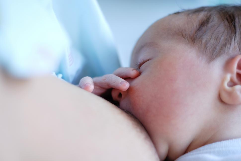 Free Image of Mother feeding breast her baby at home 