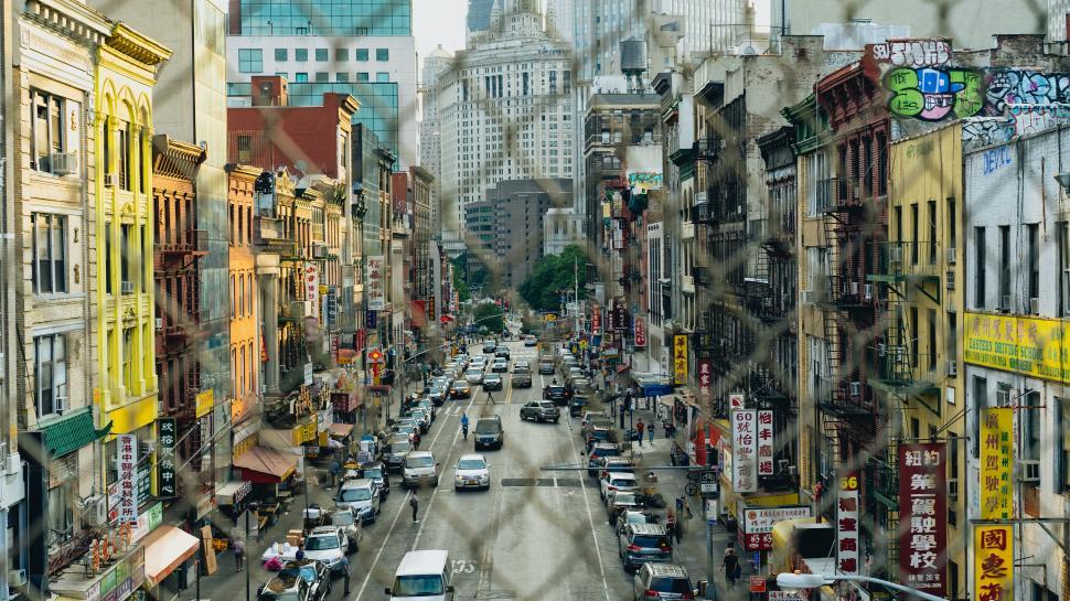 Free Image of A street with cars and buildings in the background 