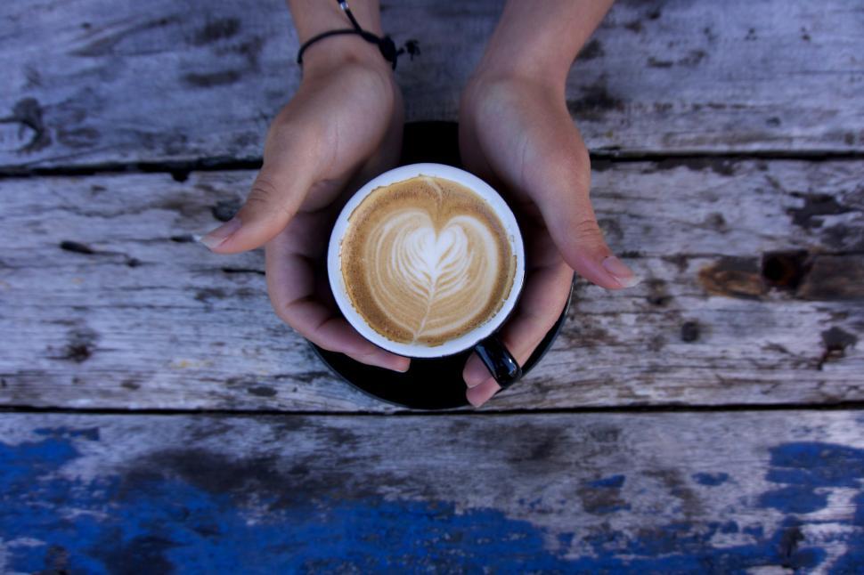 Free Image of A person holding a cup of coffee 
