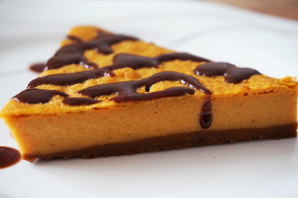 Free Image of A slice of pie with chocolate drizzled on top 
