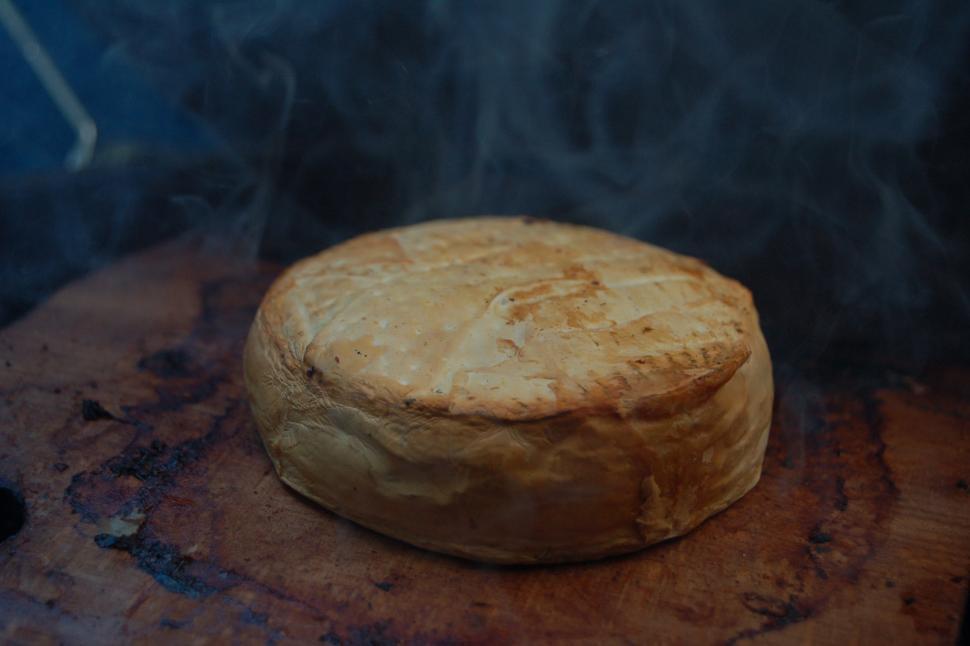 Free Image of A round brown circular object with smoke coming out of it 