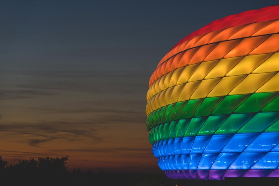 Free Image of A colorful stadium in Munich with a sunset in the background 