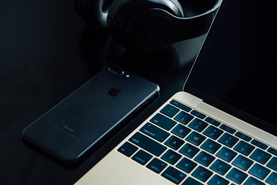 Free Image of A laptop and phone on a table 