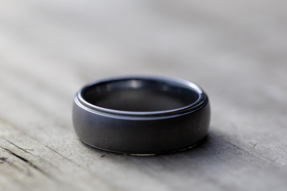 Free Image of A black ring on a wood surface 