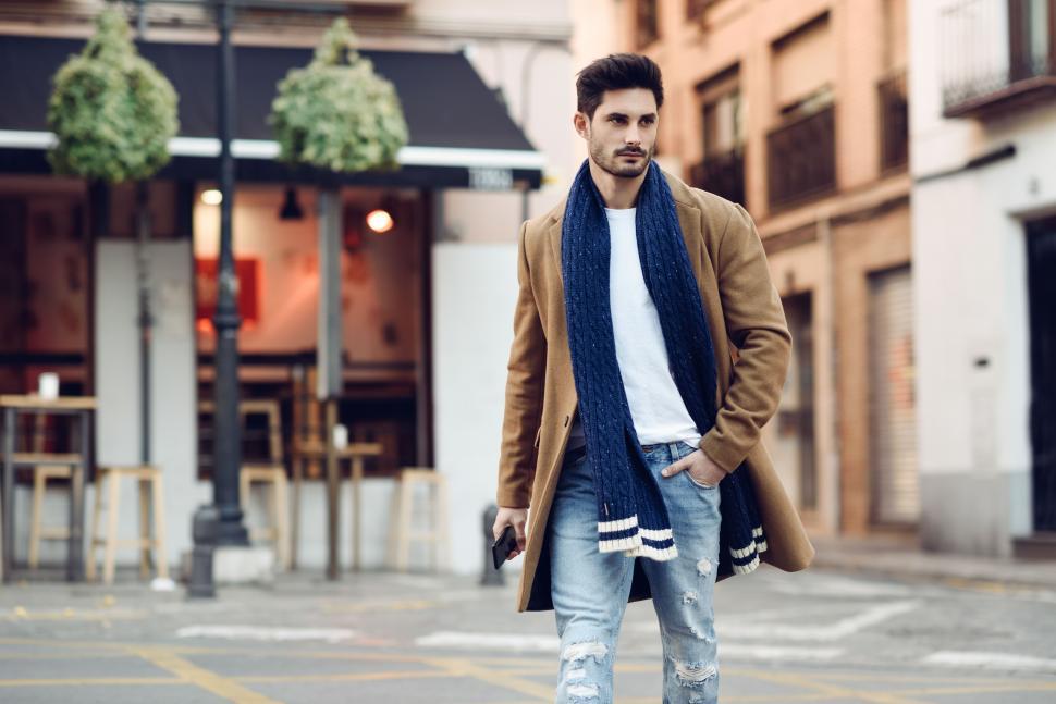 Free Image of Young man wearing winter clothes with a smartphone in his hand 