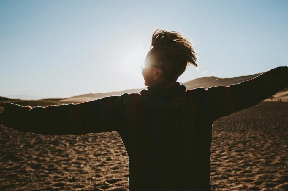 Free Image of A person with their arms out in the air 