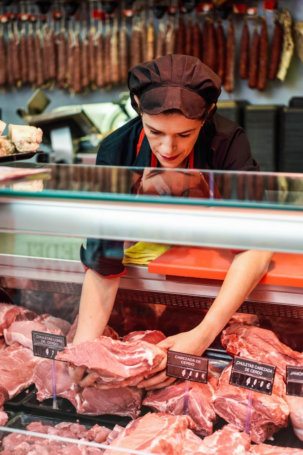 Free Image of Butcher s hands holding meat piece in shop 
