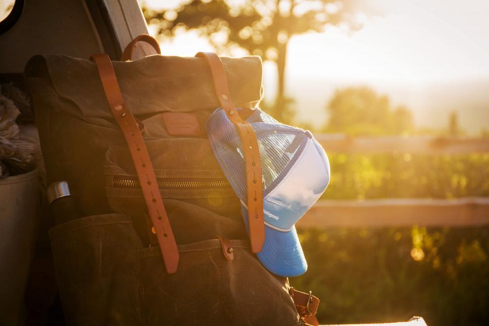 Free Image of A backpack with a cap and a baseball cap on it 