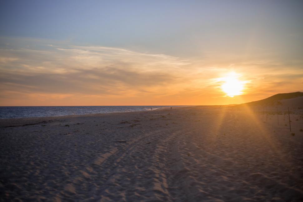 Free Image of A sunset over a beach 