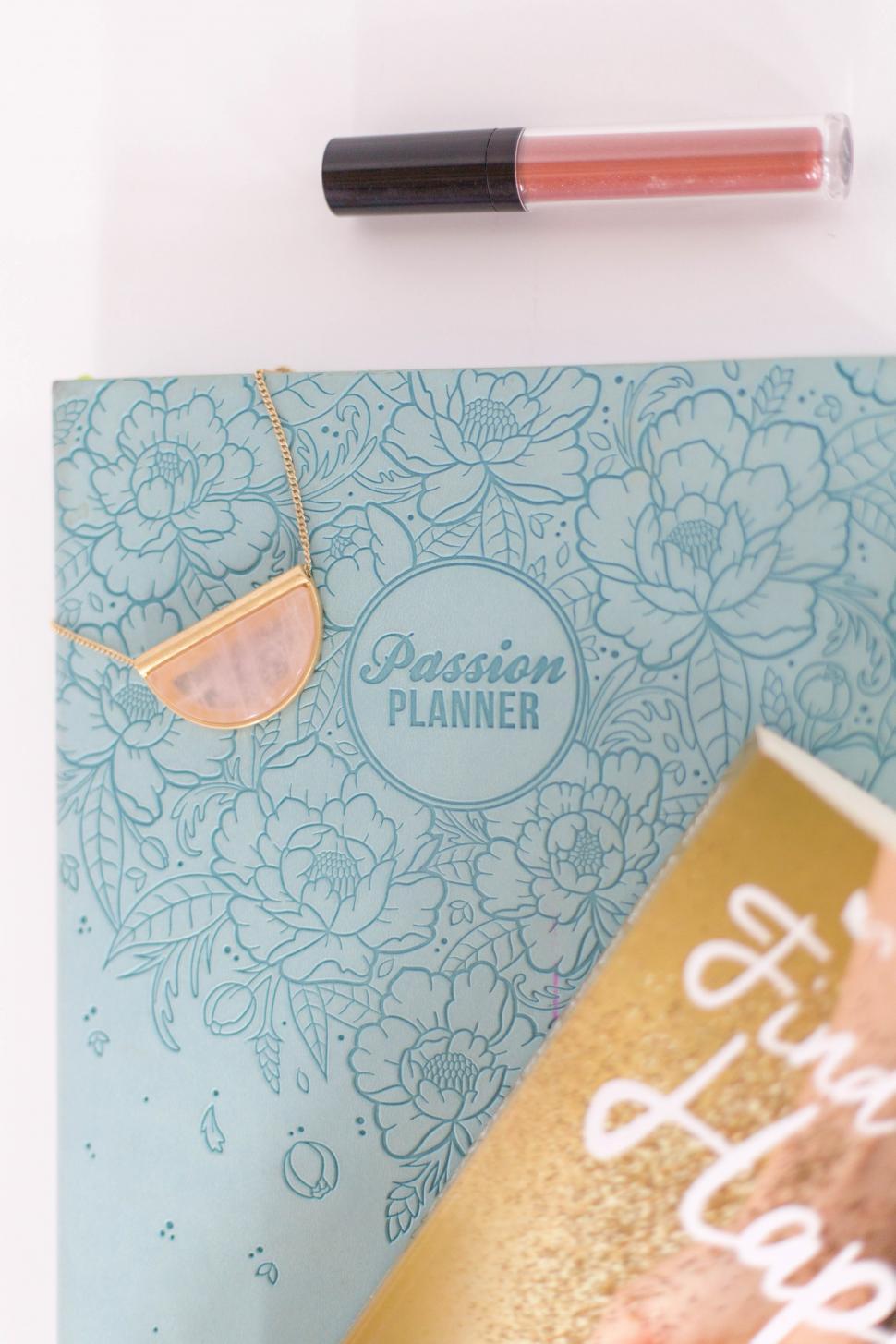 Free Image of A blue book with a necklace and a gold book 