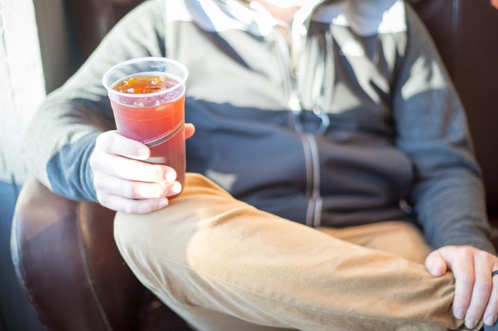 Free Image of A person holding a cup of liquid 