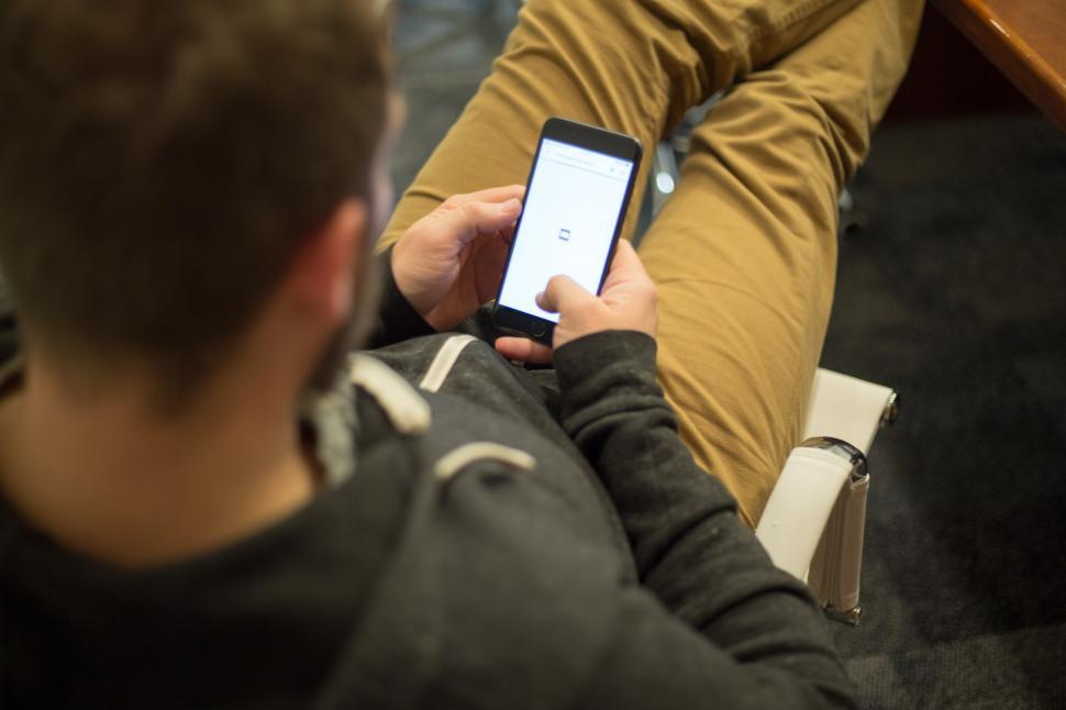 Free Image of A man holding a phone 