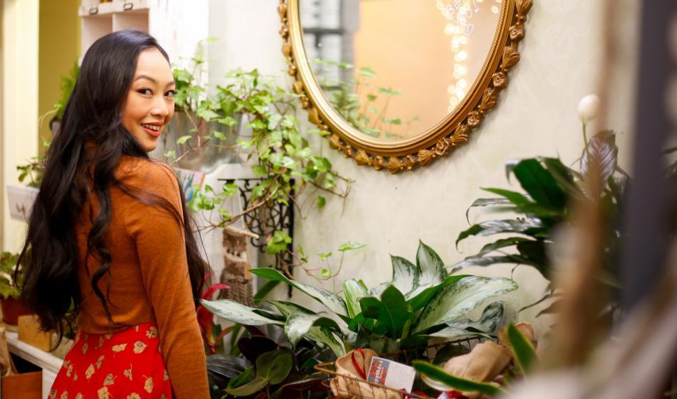 Free Image of A woman looking at a mirror 