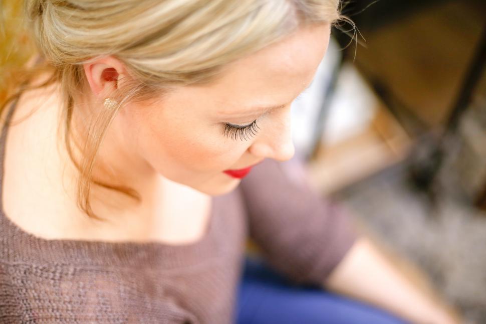 Free Image of A woman looking down at something 