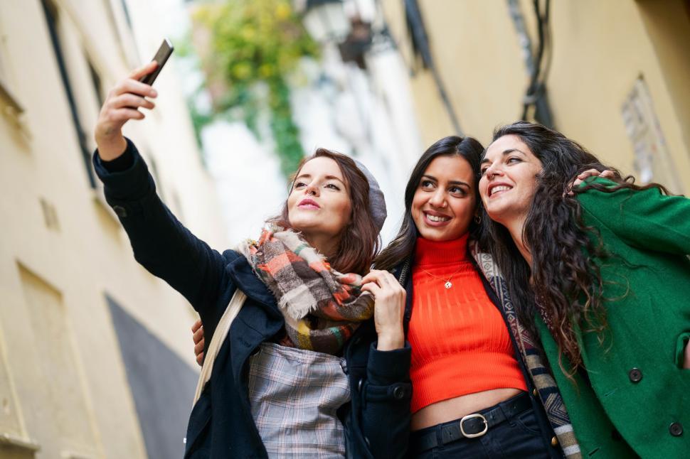 Free Image of Group of three happy woman walking together outdoors 