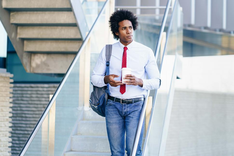 Free Image of Black Businessman taking a coffee break with a take-away glass 