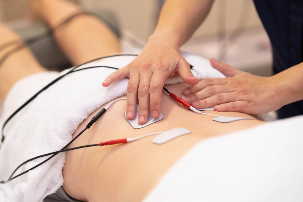 Free Image of Electro stimulation in physical therapy to a young woman 