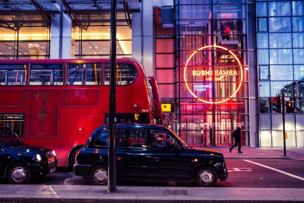 Free Image of A double decker bus and cars on a street 