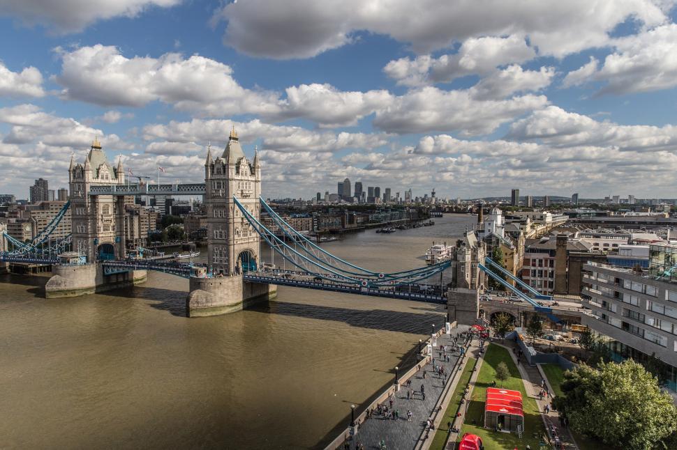 Free Image of A bridge over a river with a bridge and a city in the background 