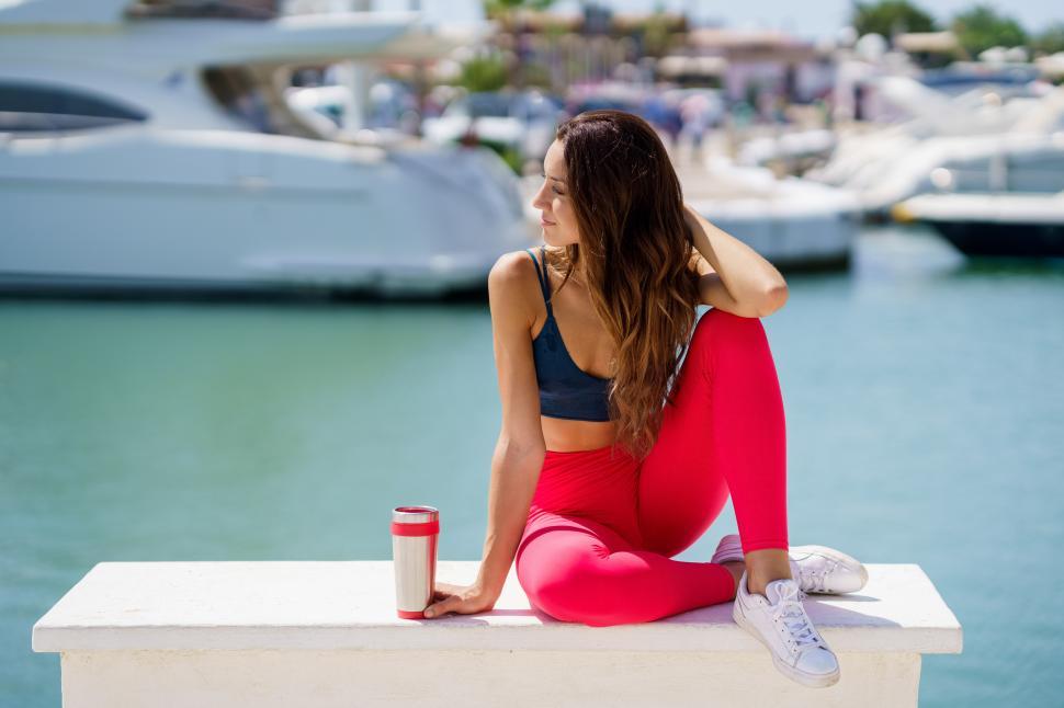 Free Image of Fitness girl in sportswear outfit training resting to hydrate after exercise. 