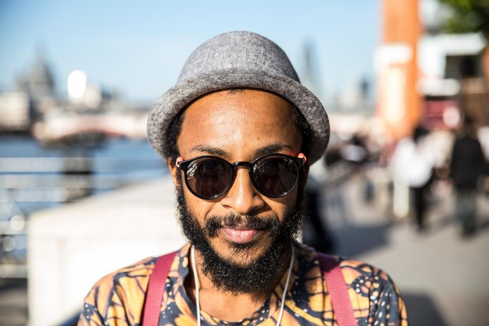 Free Image of A man wearing sunglasses and a hat 