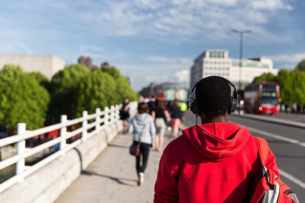 Free Image of A person wearing headphones on a sidewalk 