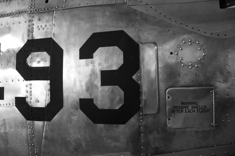 Free Image of A metal surface with numbers and rivets 