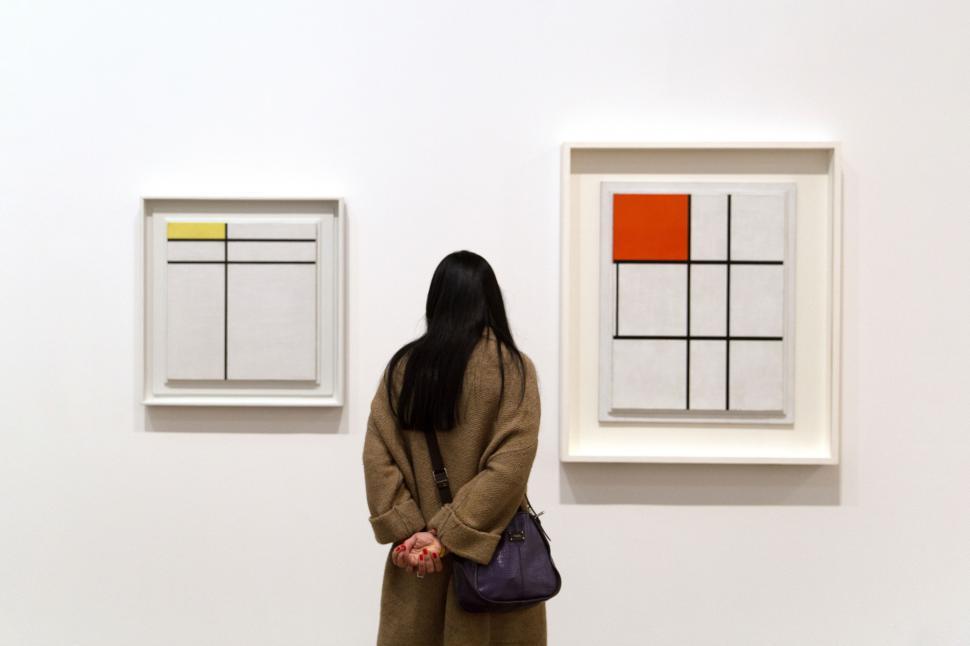 Free Image of A woman looking at a painting 