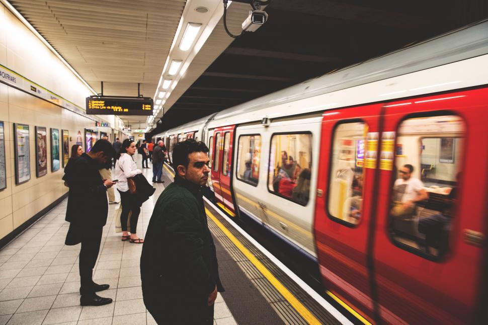 Free Image of A group of people standing in a subway station 