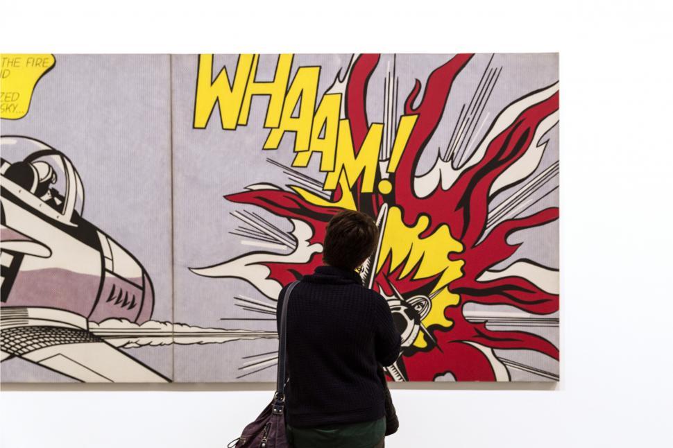 Free Image of A woman looking at a painting 