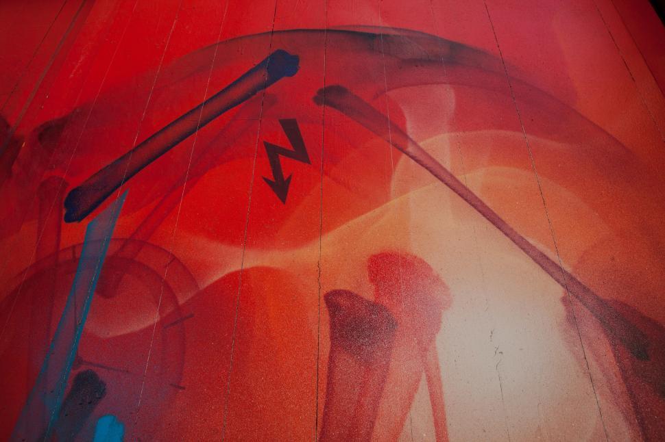 Free Image of A red and blue wall with a painting of bones and lightning 