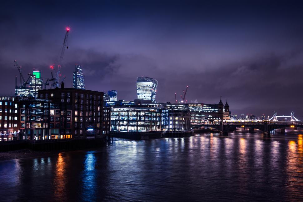Free Image of A city skyline at night with a body of water 