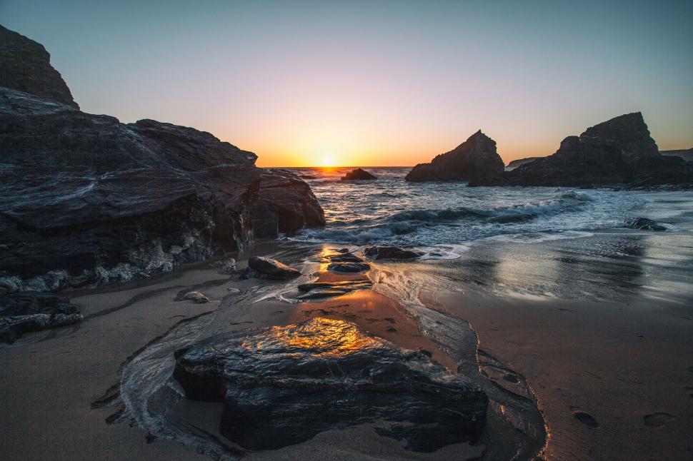 Free Image of A sunset over a beach 