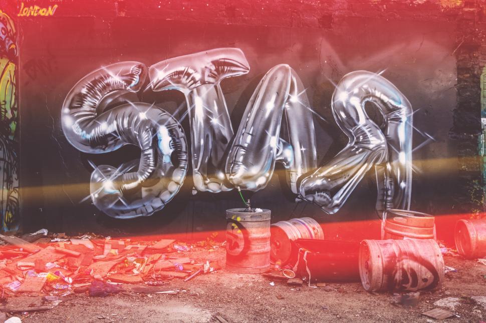 Free Image of A silver balloon painting, spelling out STAR 