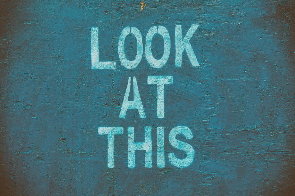 Free Image of A blue sign with white text Look At This 