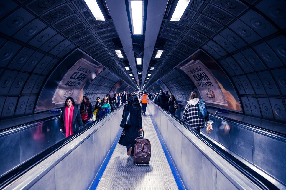 Free Image of A group of people on an escalator 