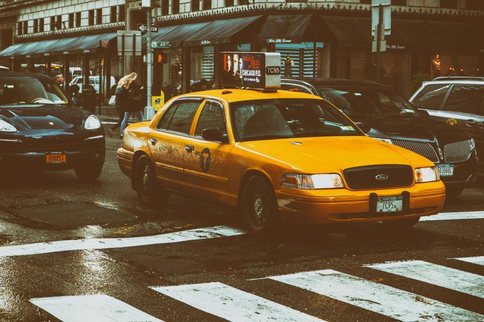 Free Image of A yellow taxi on a street 
