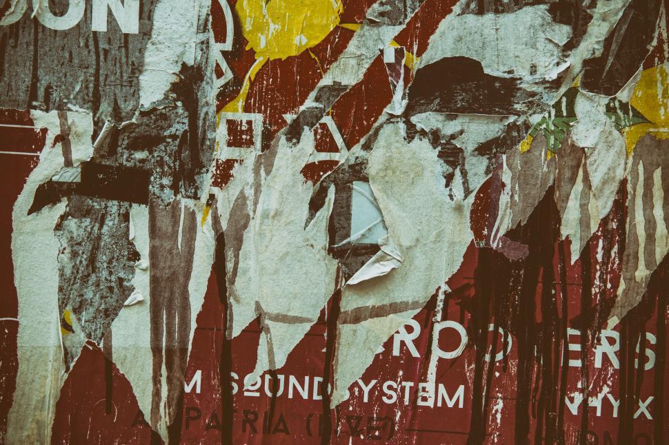 Free Image of A wall with torn posters 