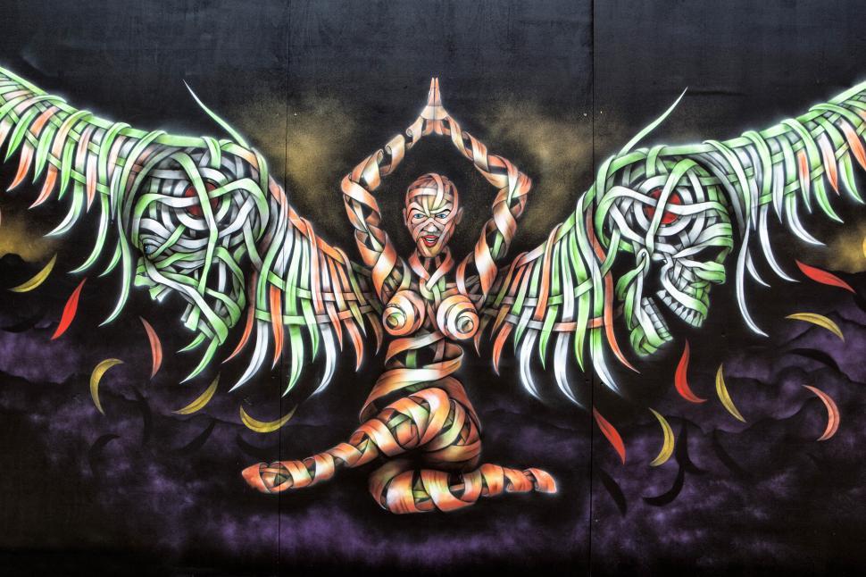 Free Image of A mural of a woman with wings and a dragon 