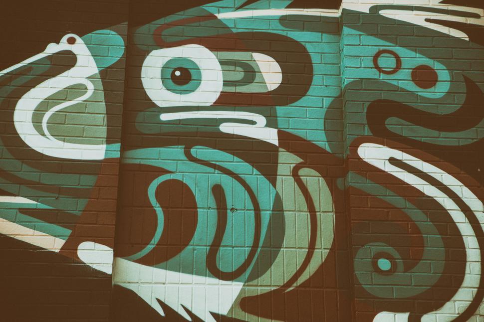 Free Image of A wall with a painting of a bird 