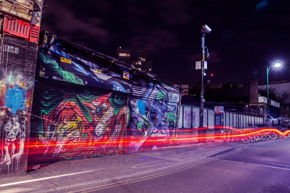Free Image of A street with graffiti on the side of a building 