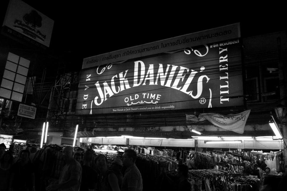 Free Image of A large sign with a crowd of people in front of it 