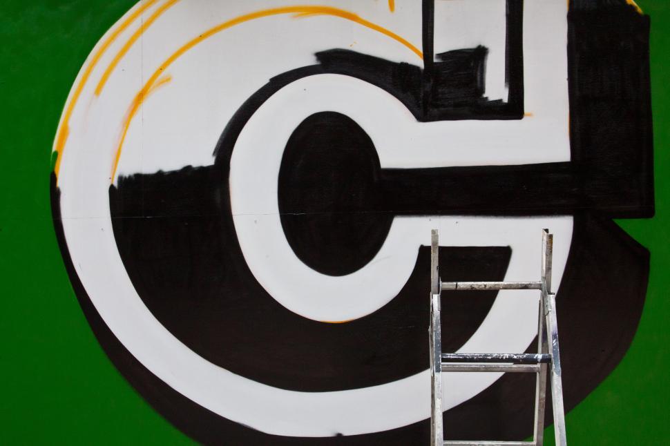 Free Image of A ladder next to a painted wall 