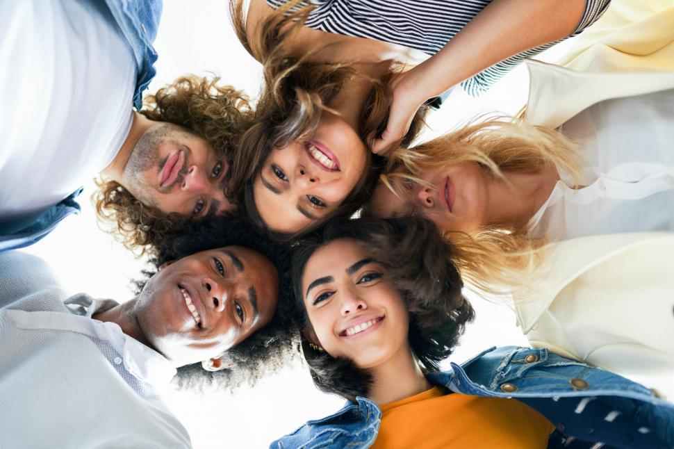 Free Image of Multi-ethnic group of friends with their heads together in a circle. 