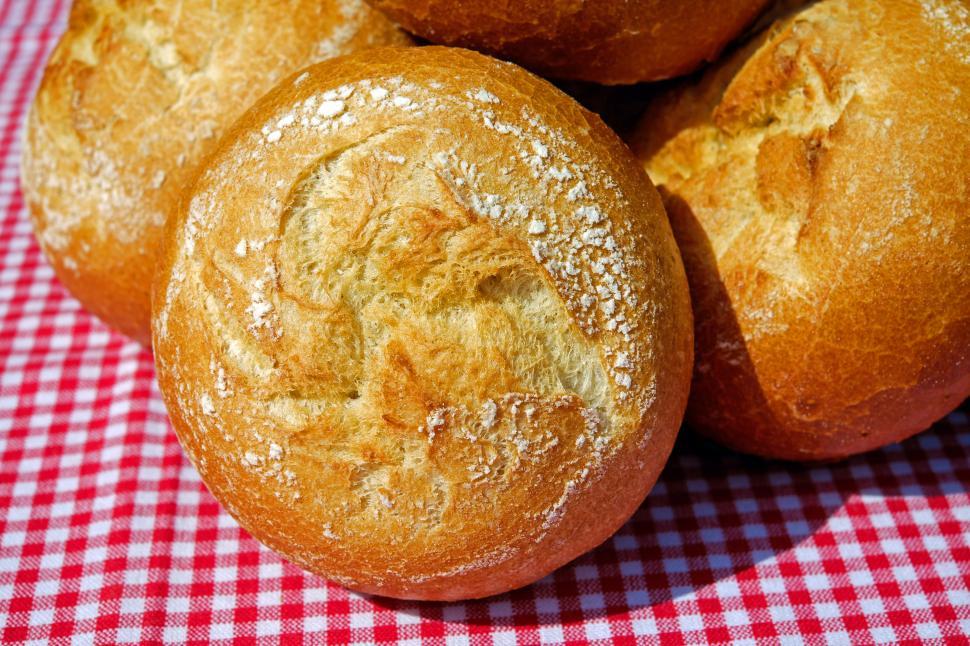 Free Image of A group of rolls on a red and white checkered tablecloth 