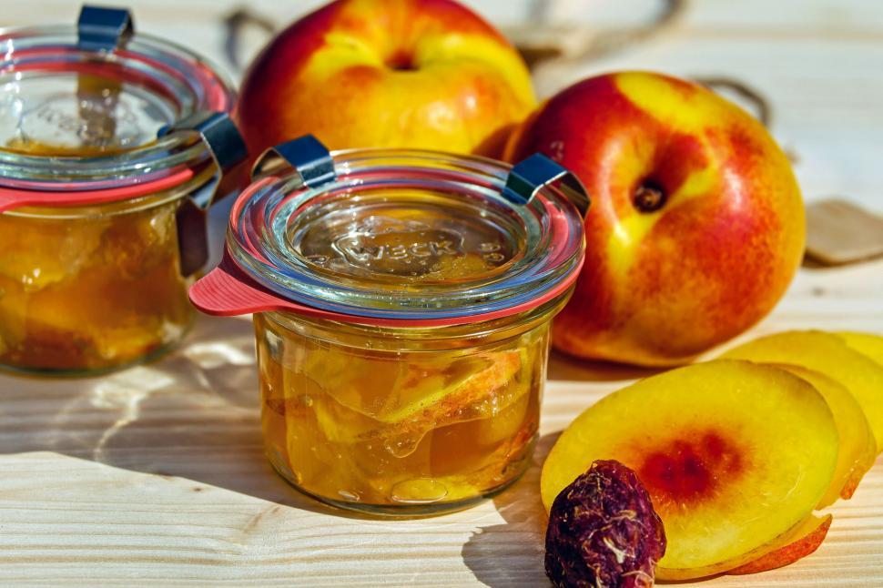 Free Image of A jar of jam next to fruit 