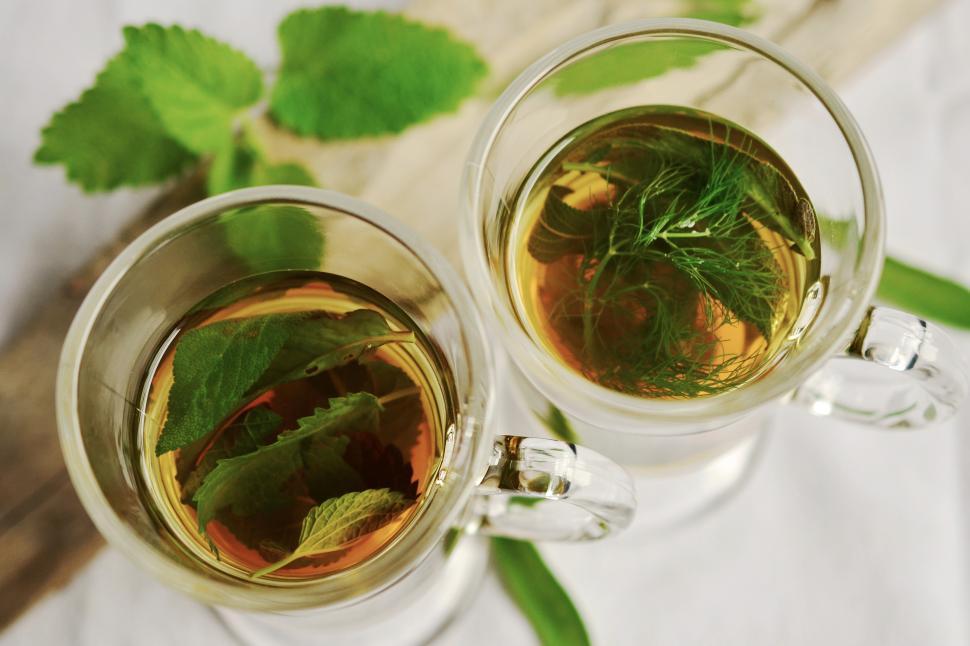 Free Image of Two cups of liquid with leaves in them 
